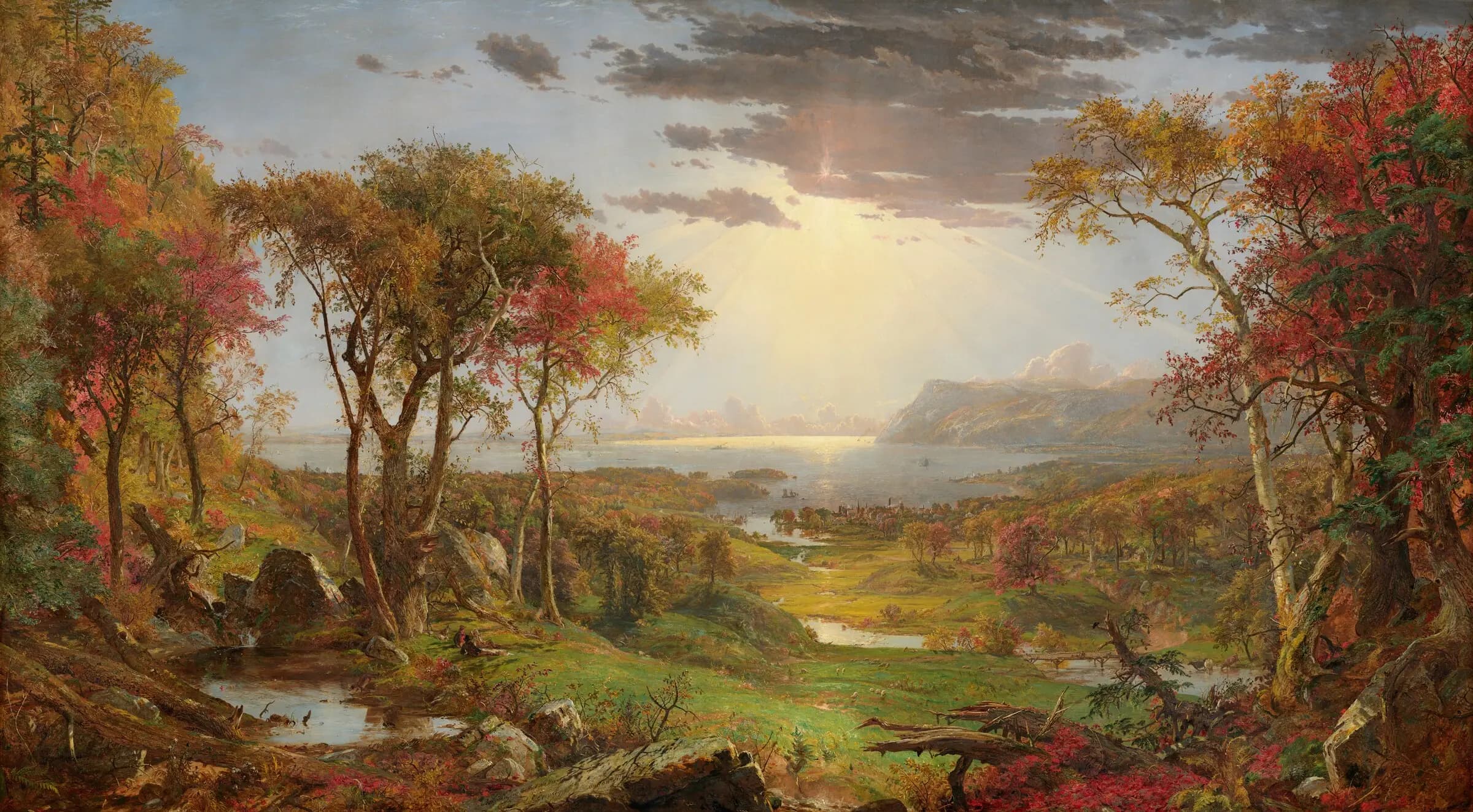 Cropsey’s autumn landscape, with colorful foreground trees, a stream, and the distant Hudson River beneath a sunlit sky.